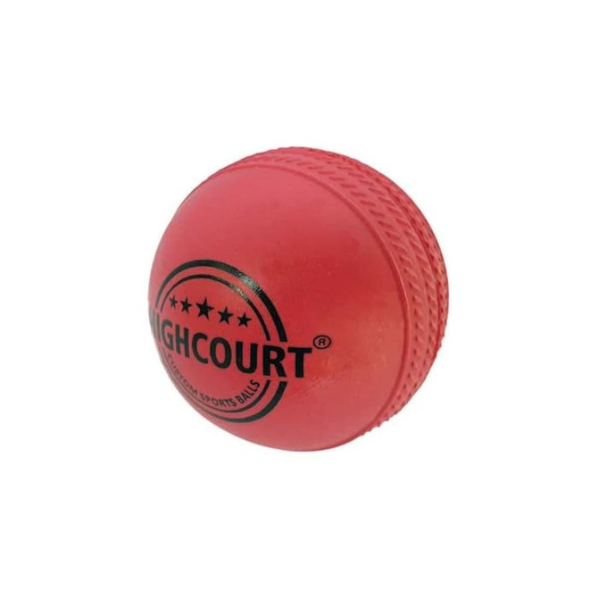 A rubber cricket ball in bright red with black branding and textured seams.