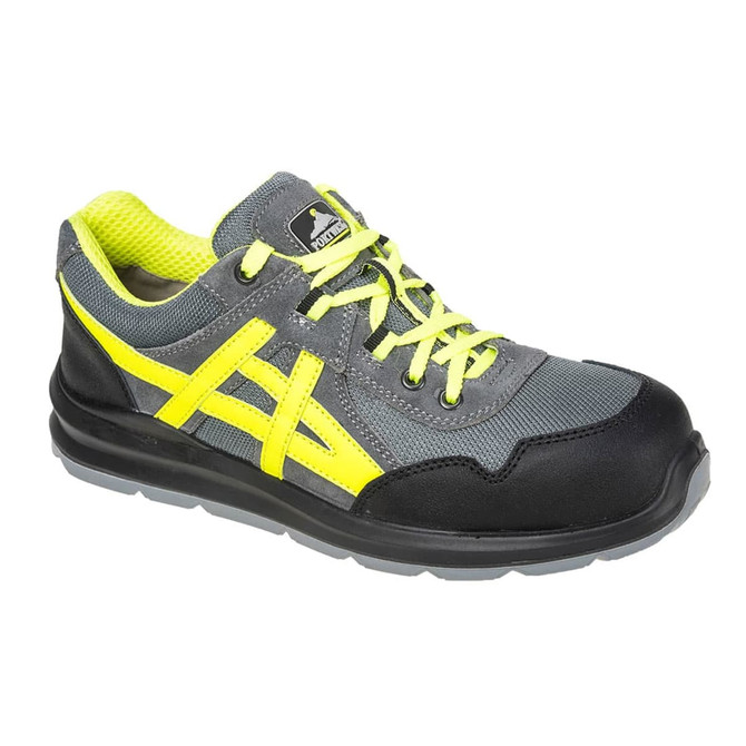 A grey and black trainer with yellow accents, featuring laces and a sturdy, protective toe cap. The shoe has a logo.