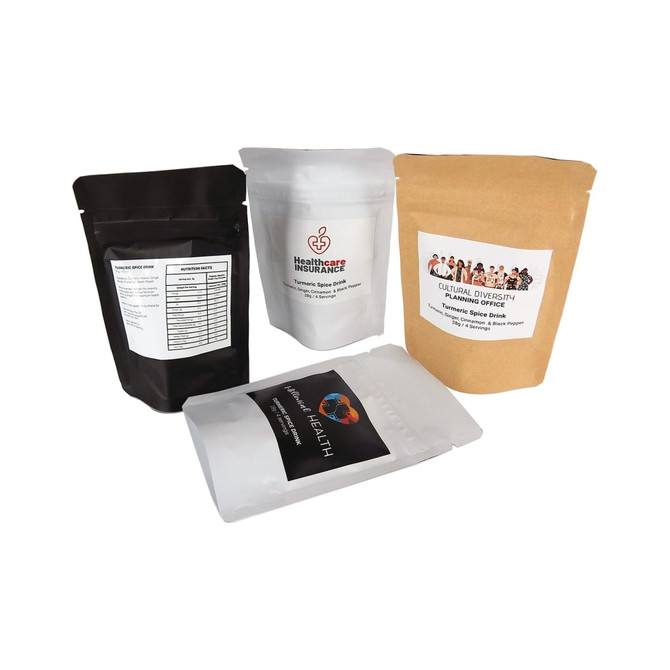 Four stand-up pouches containing various drink mixes, including a turmeric spice drink, in black, white, and brown.