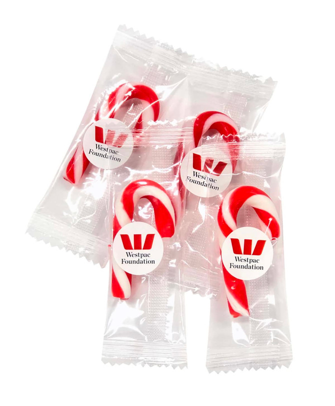 Four red and white candy canes packaged individually, featuring a logo on each wrapper.