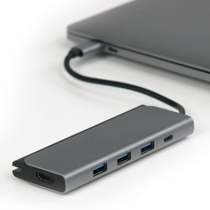 A grey USB hub with multiple ports connected to a laptop, featuring a sleek, modern design.