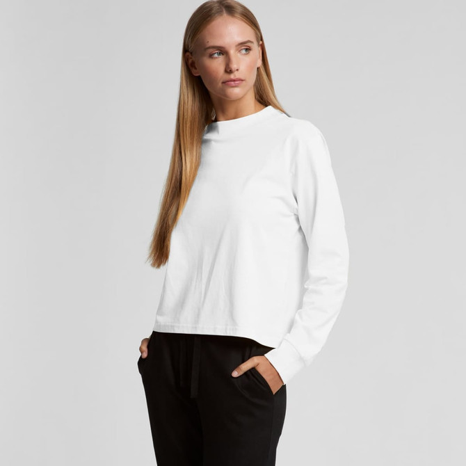 A white long-sleeve t-shirt with a crew neck, featuring a model in a relaxed pose. The shirt has a logo.