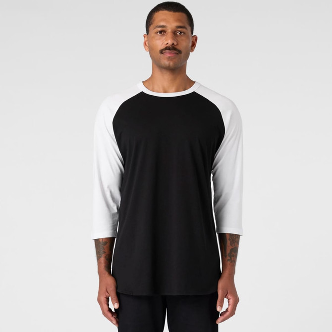 A black and white Raglan Tee featuring a crew neck and three-quarter sleeves, with a logo present.