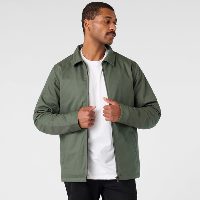 A green service jacket worn by a man, featuring a collared design and a branding logo.