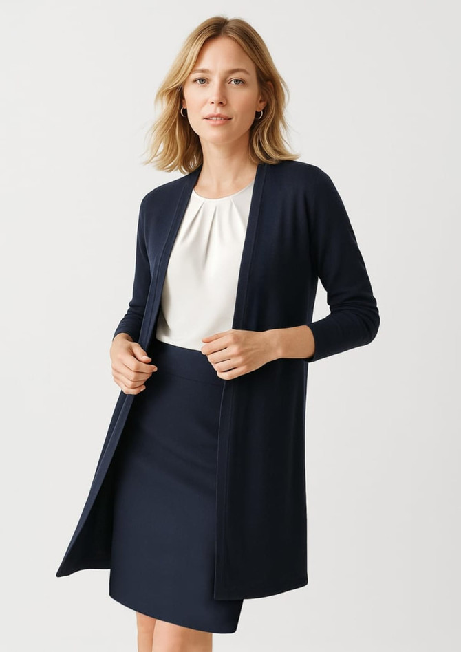 A longline cardigan in navy blue, featuring a open front and long sleeves, paired with a white top and skirt. A longline cardigan in navy blue, featuring a open front and long sleeves, paired with a white top and skirt.