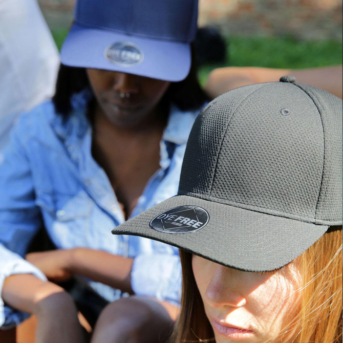 Two people wearing caps, one in navy blue and the other in olive green, both featuring a logo.