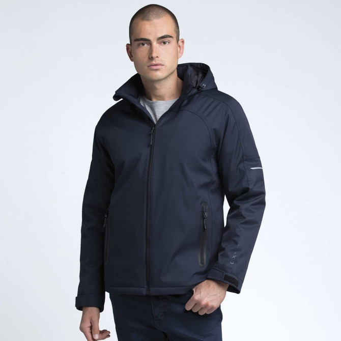 A man wearing a navy soft shell jacket with a hood, featuring zippered pockets and a logo on the sleeve.