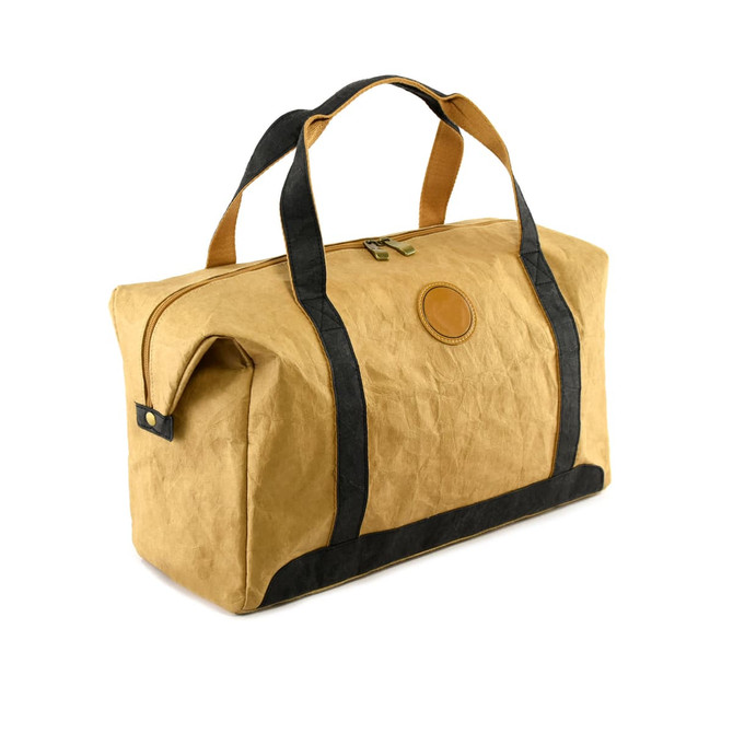 A tan kraft paper duffle bag with black accents and handles, featuring a round logo on the side.