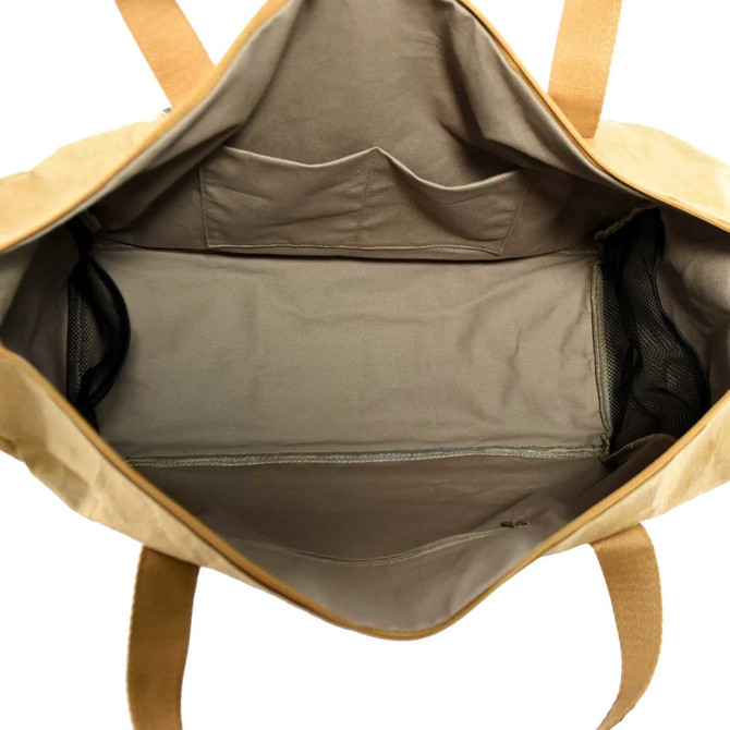 A tan Kraft paper travel bag with a spacious interior and multiple pockets for organisation. It features a logo.