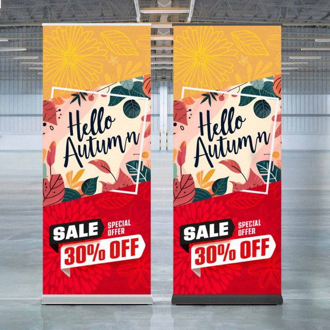 Two vertical pull-up banners featuring autumn-themed designs with floral patterns in warm colours of orange, red, and yellow.