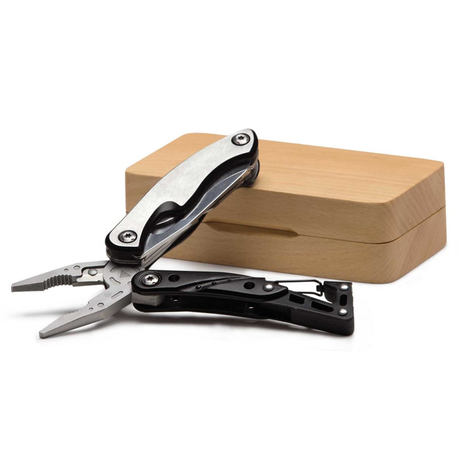 A multi-tool with pliers features a silver and black design, displayed beside a wooden box.
