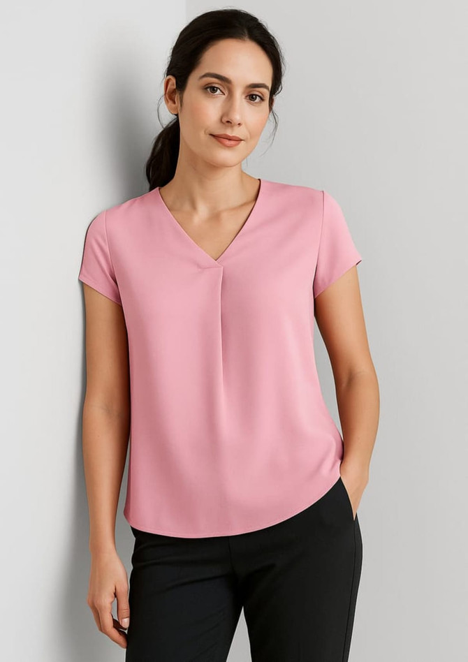 A pink women's blouse with a V-neck and pleat detail, featuring short sleeves and a relaxed fit.