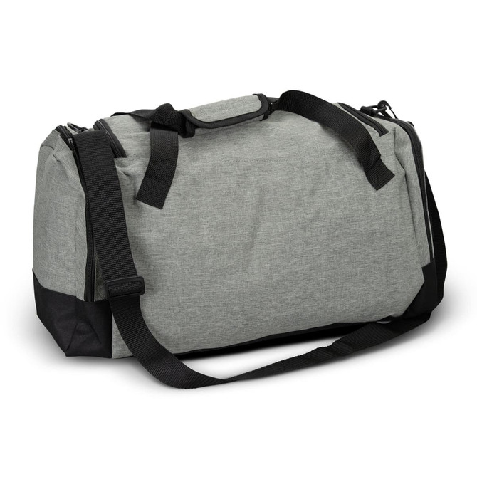 A grey duffle bag with black accents, featuring dual handles and a removable shoulder strap. It has a logo on the side.