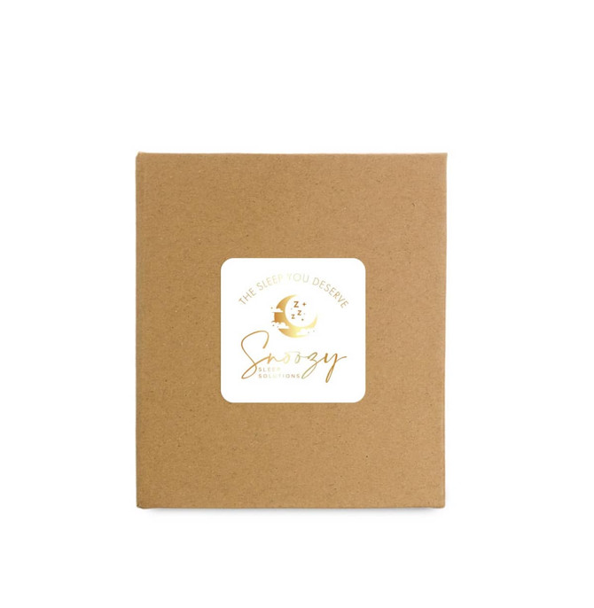 A brown cardboard box featuring a logo with gold accents and sleep-themed graphics.