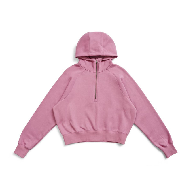 A pink half-zip jumper with a hood and a cropped design, featuring a logo.