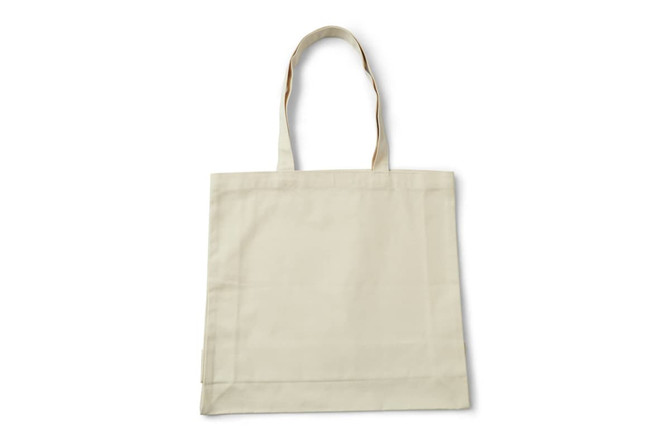 A cream tote bag with two sturdy handles and a simple design. It has a logo on one side.