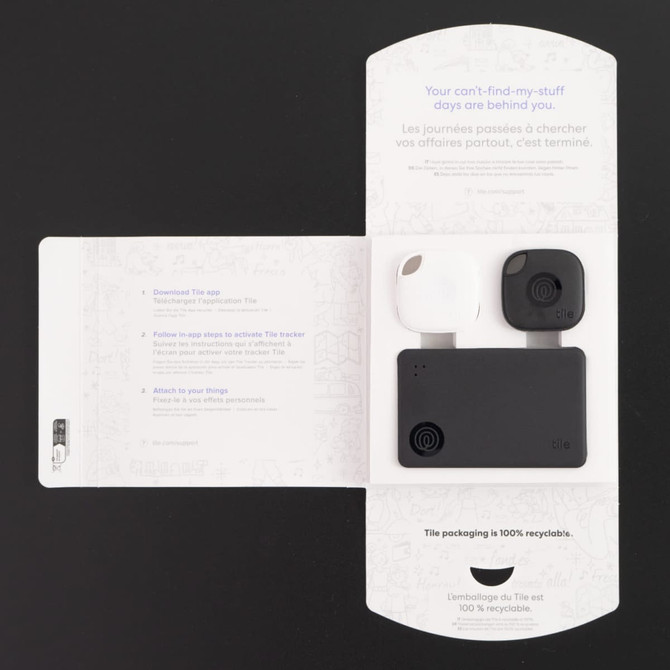 A Tile Combo Pack featuring a black and white tracking device, presented in a cardboard package with a design.