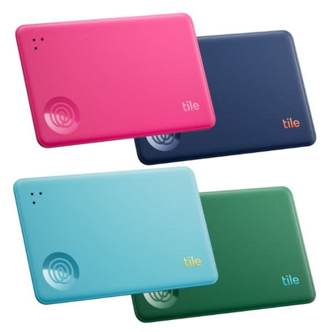 A set of four Tile Slim devices in pink, blue, dark blue, and green, featuring a logo on each.