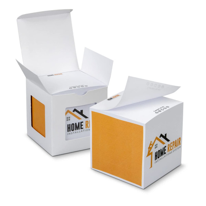 A sticky cube in white and orange, featuring a logo, with two boxes partially opened. Each box contains multiple sticky sheets.