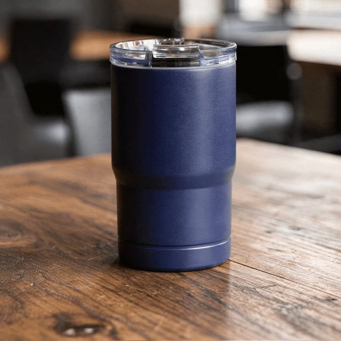 A drink bottle featuring a navy blue design with a clear lid, set on a wooden table. It includes a logo.