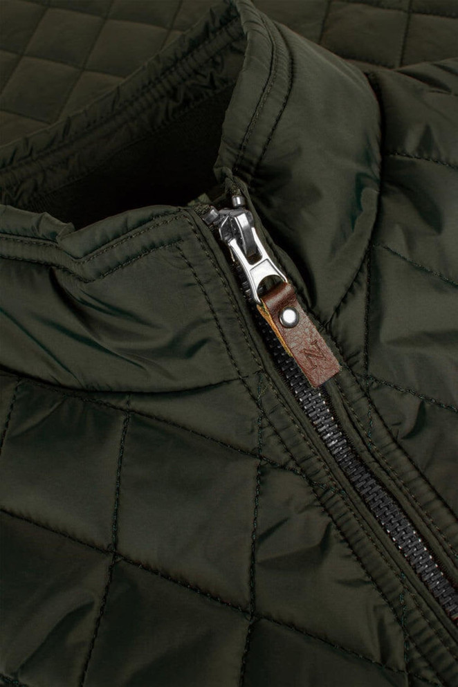 A quilted green vest featuring a zip closure and a leather accent on the zipper.