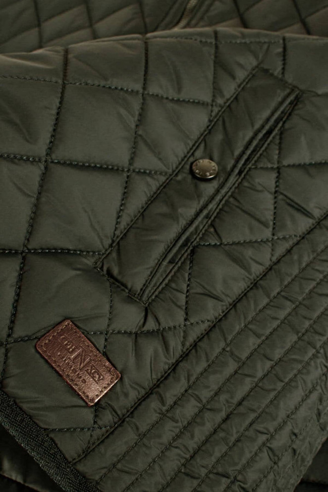 A quilted green vest featuring a logo patch, with button and snap closures on the front.