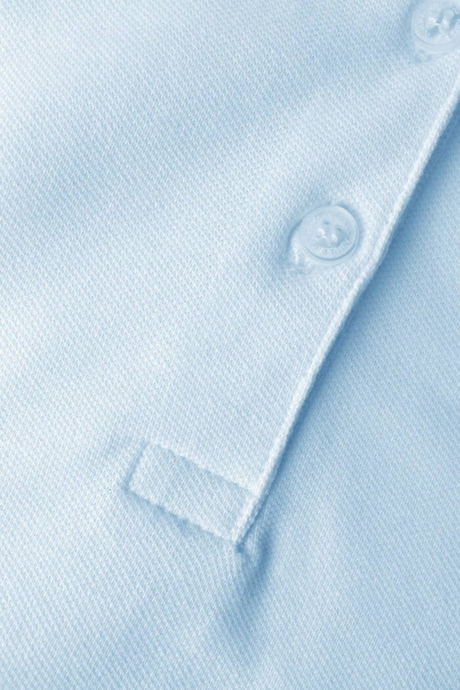 A light blue polo shirt featuring a button placket and a textured fabric. It has a logo on the front.