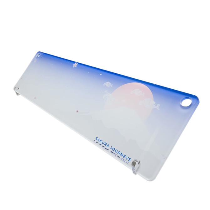 A translucent desk mat featuring a gradient blue and white design with a mountain and sun illustration, plus branding. A translucent desk mat featuring a gradient blue and white design with a mountain and sun illustration, plus branding.