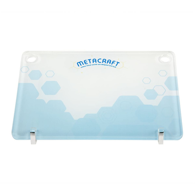 A clear glass desk mat with a blue and white geometric design, featuring the logo "METACRAFT" at the top. A clear glass desk mat with a blue and white geometric design, featuring the logo "METACRAFT" at the top.