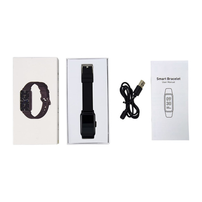 A slim black smart watch in a box, alongside a user manual and a USB charging cable.