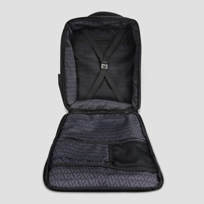 An open black travel backpack with multiple compartments and a patterned inner lining. It features adjustable straps inside.