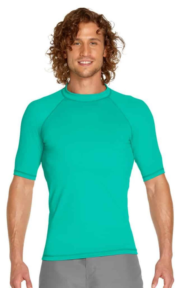 A short sleeve rashie in teal with a snug fit and stretch fabric, featuring a logo on the chest.