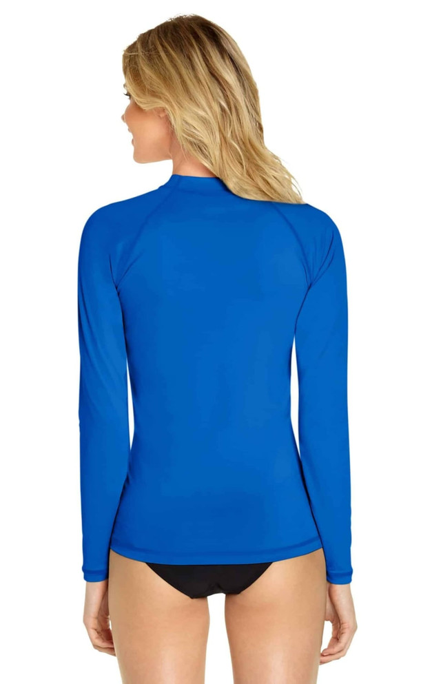 A bright blue long sleeve rashie with a fitted design and a high neck, featuring a logo on the back.