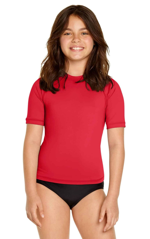 A red youth short sleeve rashie with UPF 50+ protection, featuring a black bikini bottom. The product has a logo.