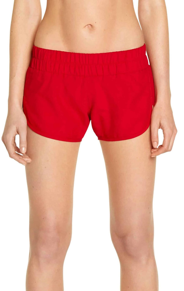 A pair of red swim shorts with an elastic waistband, designed for women, featuring a logo.
