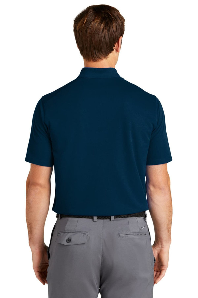 A navy blue polo shirt with a short sleeve and a pocket, featuring a logo. The view is from the back.