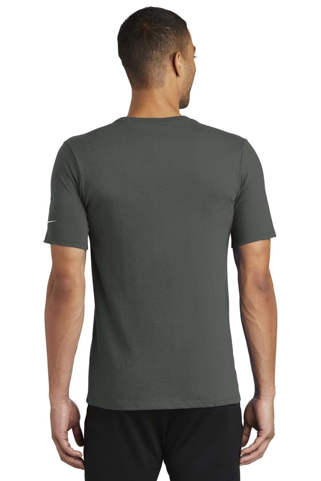 A man wearing a green Nike Dri-FIT cotton/polyester T-shirt, shown from the back. The shirt features a logo. A man wearing a green Nike Dri-FIT cotton/polyester T-shirt, shown from the back. The shirt features a logo.