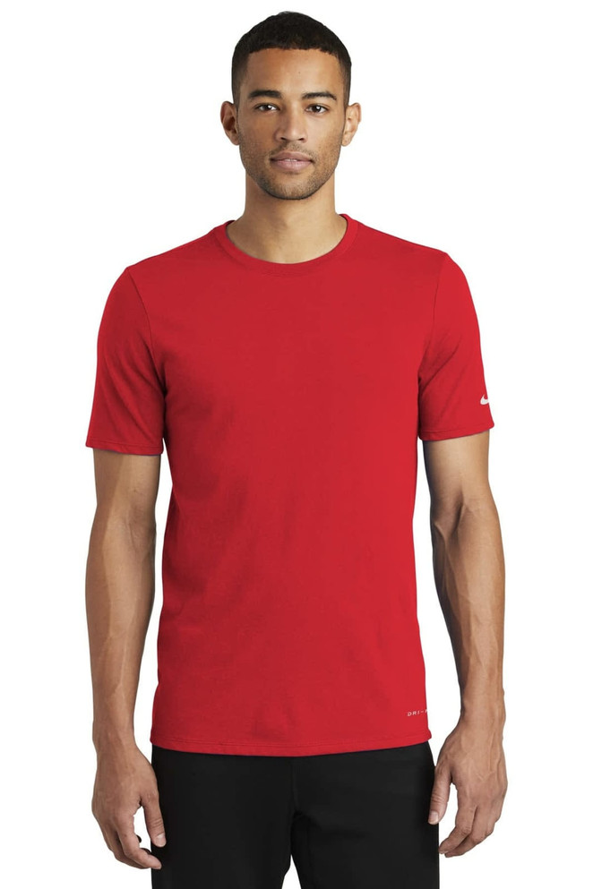 A red Nike Dri-FIT Cotton/Poly Tee on a male model, featuring a logo on the sleeve. A red Nike Dri-FIT Cotton/Poly Tee on a male model, featuring a logo on the sleeve.