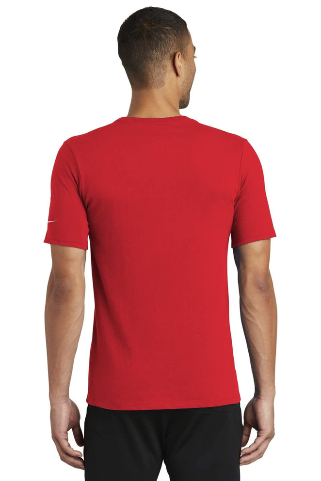 A red Nike Dri-FIT Cotton/Poly Tee displayed on a model from the back, featuring a logo on the sleeve. A red Nike Dri-FIT Cotton/Poly Tee displayed on a model from the back, featuring a logo on the sleeve.
