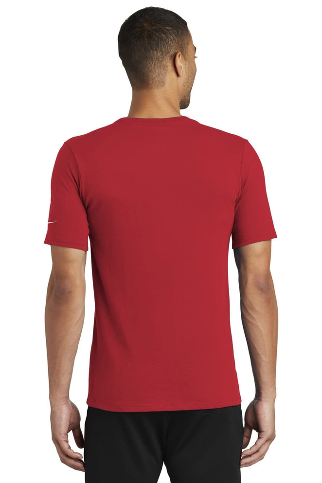 A red Nike Dri-FIT Cotton/Poly Tee featuring a logo, viewed from the back on a model. A red Nike Dri-FIT Cotton/Poly Tee featuring a logo, viewed from the back on a model.