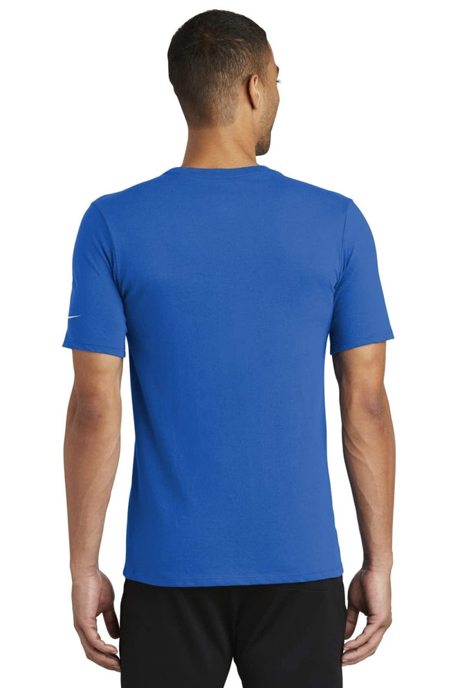 A blue Nike Dri-FIT Cotton/Poly Tee seen from the back, featuring a logo on the sleeve. A blue Nike Dri-FIT Cotton/Poly Tee seen from the back, featuring a logo on the sleeve.