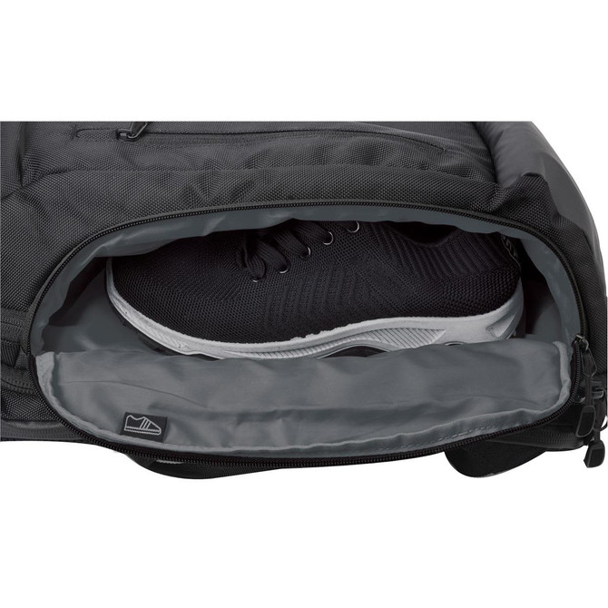 A black backpack featuring a grey compartment with a pair of black and white athletic shoes partially visible inside. A black backpack featuring a grey compartment with a pair of black and white athletic shoes partially visible inside.