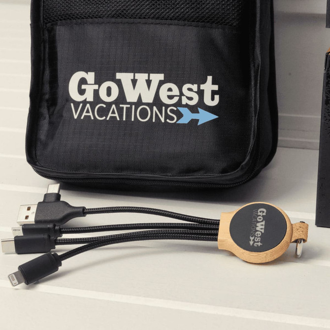 A black travel kit with a logo, featuring a multi-cable charger with USB and other connectors.