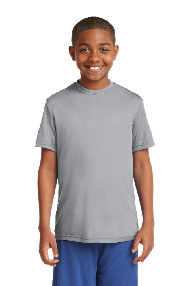 A smiling boy is wearing a grey Sport-Tek Youth PosiCharge Competitor Tee, paired with blue shorts. A smiling boy is wearing a grey Sport-Tek Youth PosiCharge Competitor Tee, paired with blue shorts.