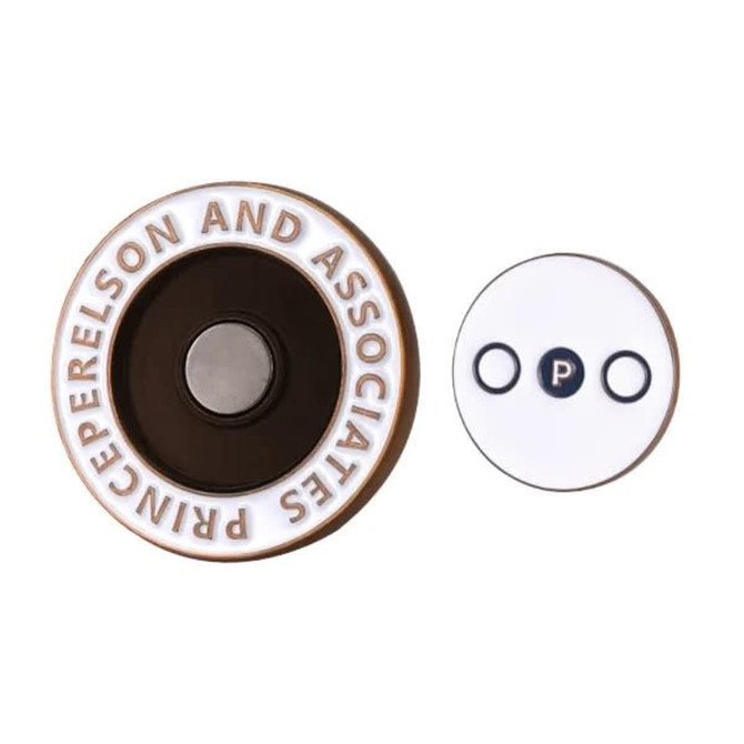 A soft enamel magnetic ball marker in brown and white with a logo, featuring a circular design and a smaller circular piece.