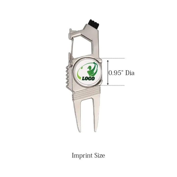 A silver divot tool with a ball marker featuring a circular insert and a logo, designed for golf enthusiasts.