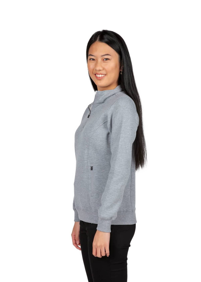 A woman wearing a grey half zip fleece jumper, featuring a fitted design and a logo on the front.