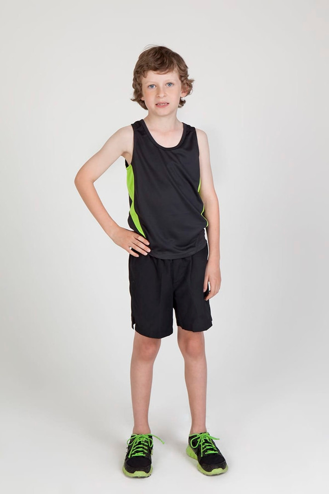 A child is wearing a black singlet with green accents and matching black shorts and shoes. The background is plain white.