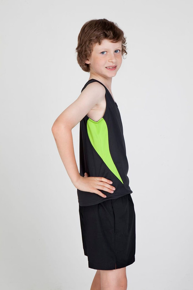 A child wearing a black singlet with green accents, paired with black shorts, posing against a plain background.