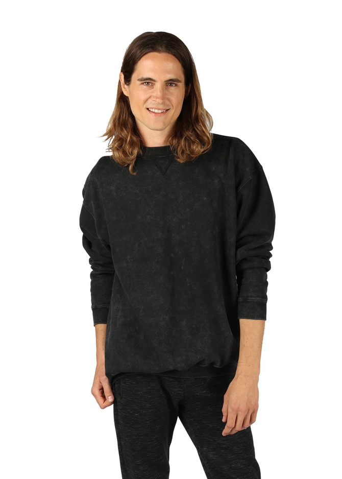 A unisex stone wash sweatshirt in black, featuring a crew neck and long sleeves. The model is posing casually. A unisex stone wash sweatshirt in black, featuring a crew neck and long sleeves. The model is posing casually.